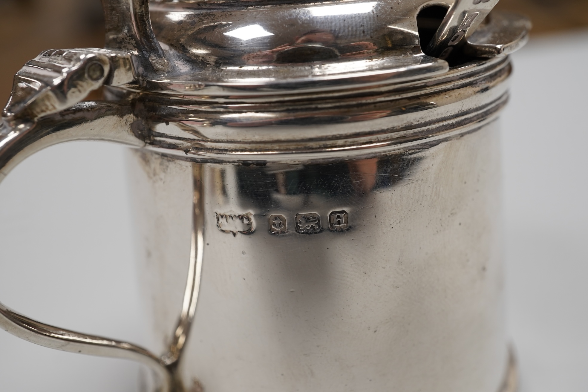 A George V silver drum mustard by Mappin & Webb, Birmingham, 1923, height 71mm, with associated spoon, together with a pair of George V silver pepperettes, Adie Brothers, Birmingham, 1923.